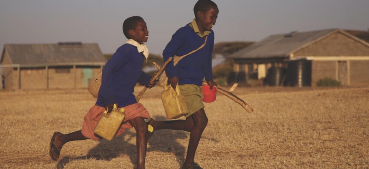 Two kids running outside