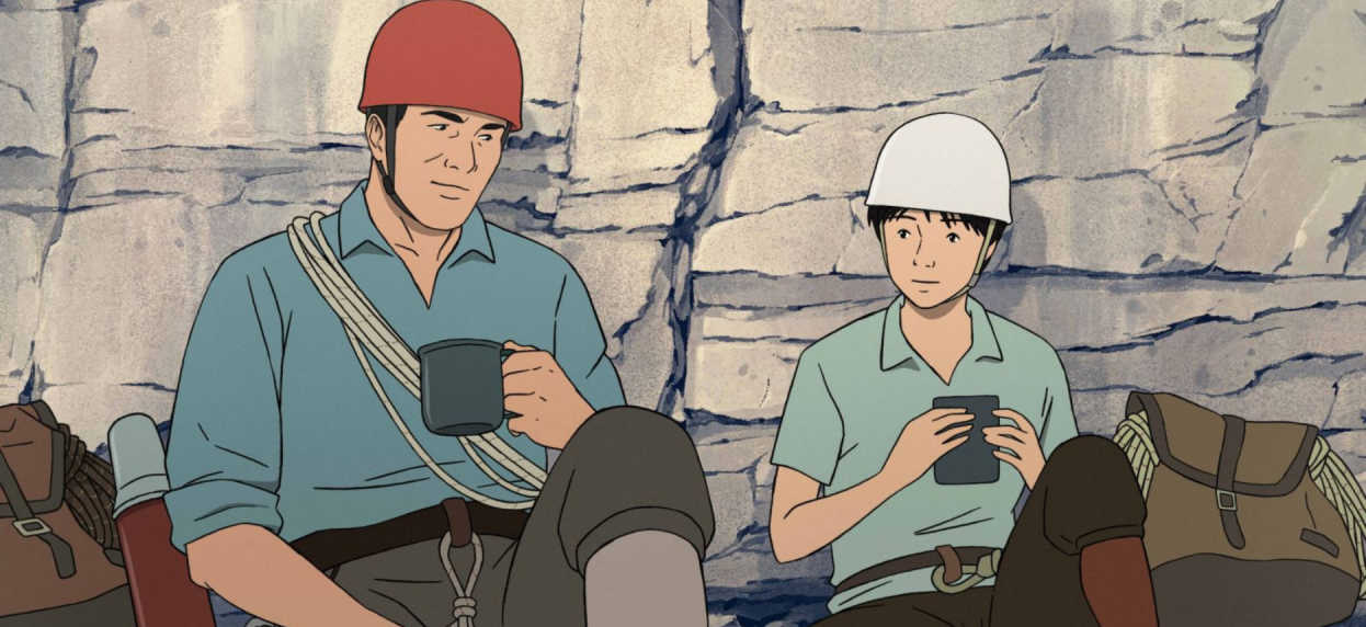 A man and woman in helmets and climbing gear sit in front of a rock face and drink out of mugs in this still from animated film The Summit of the Gods.